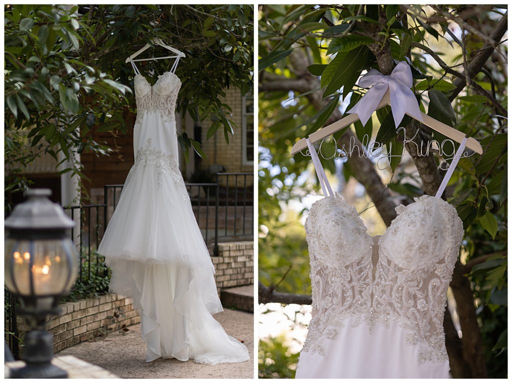 Close up of bride’s dress hanging in a tree