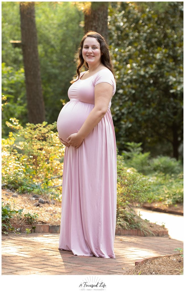 Pregnant mom posing for maternity pictures at Vines Park in Loganville