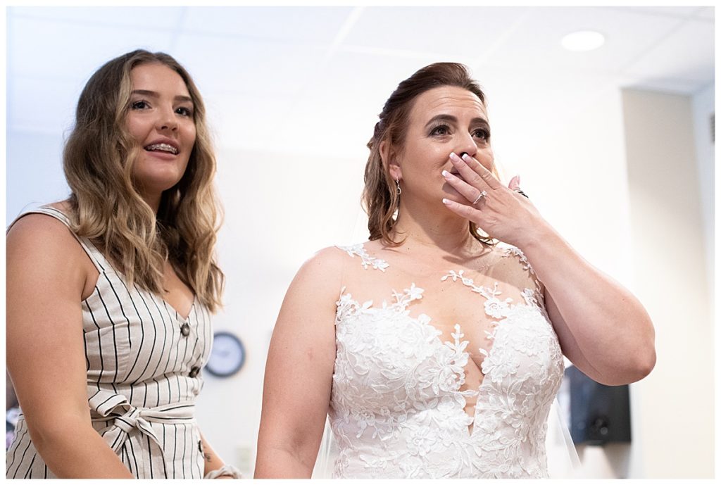 Bride seeing her reflection in the mirror as a bride for the first time on her wedding day