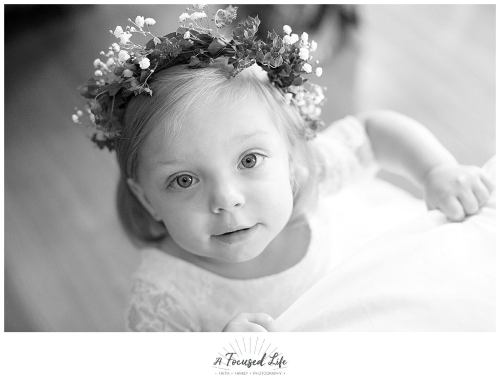 Flower girl getting dressed for Intimate white chapel summer wedding at Foster Brady Farm in Monroe, GA by Georgia wedding photographers A Focused Life Photography
