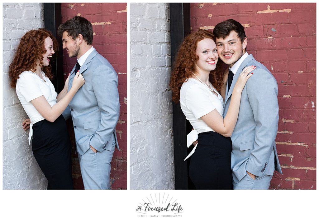 Romantic engagement session against red and white brick wall