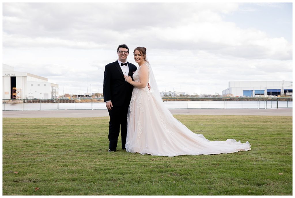 Posed photo of bride and groom at Cooper Riverside Park in Mobile, AL