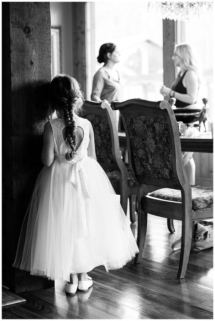 Black and white of Flower girl looking at Bride