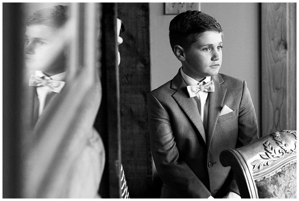 black and white of Groom helping son get ready 