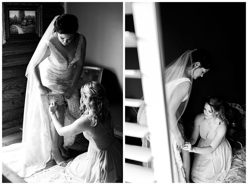Black and white of maid of honor putting garter n bride