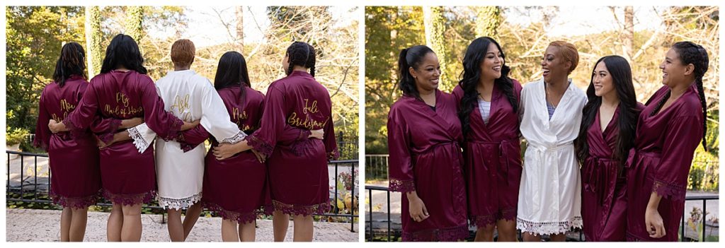 Bride and bridesmaids wearing matching dark red robes outside smiling