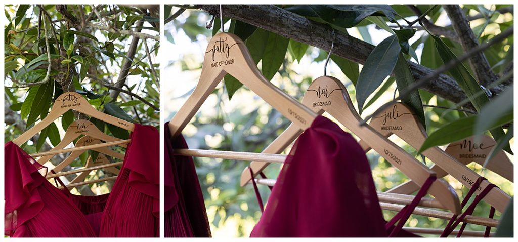 Close up of bridesmaids dresses hanging in a tree outside