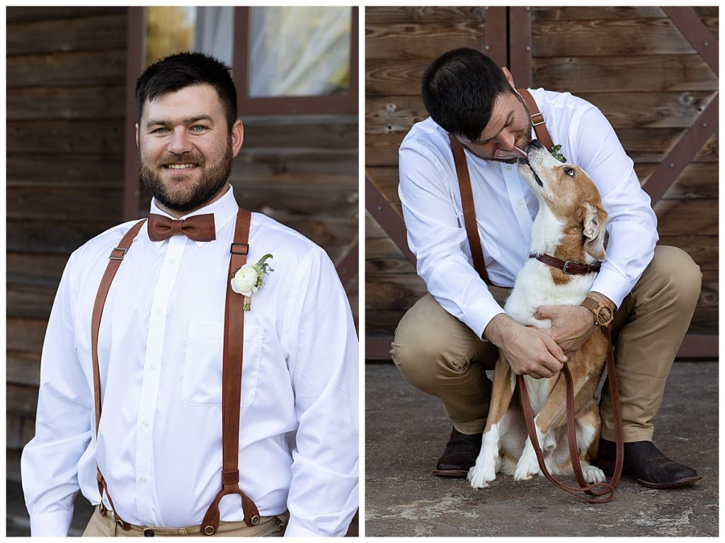 Groom in wedding attire with dog outside in front of wooden building